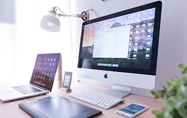 image of 1 MAC laptop next to 1 MAC desktop